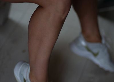 Close-up of athletic shoes on a gym floor.