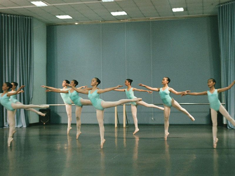 Man performing a complex bodyweight exercise with perfect form.